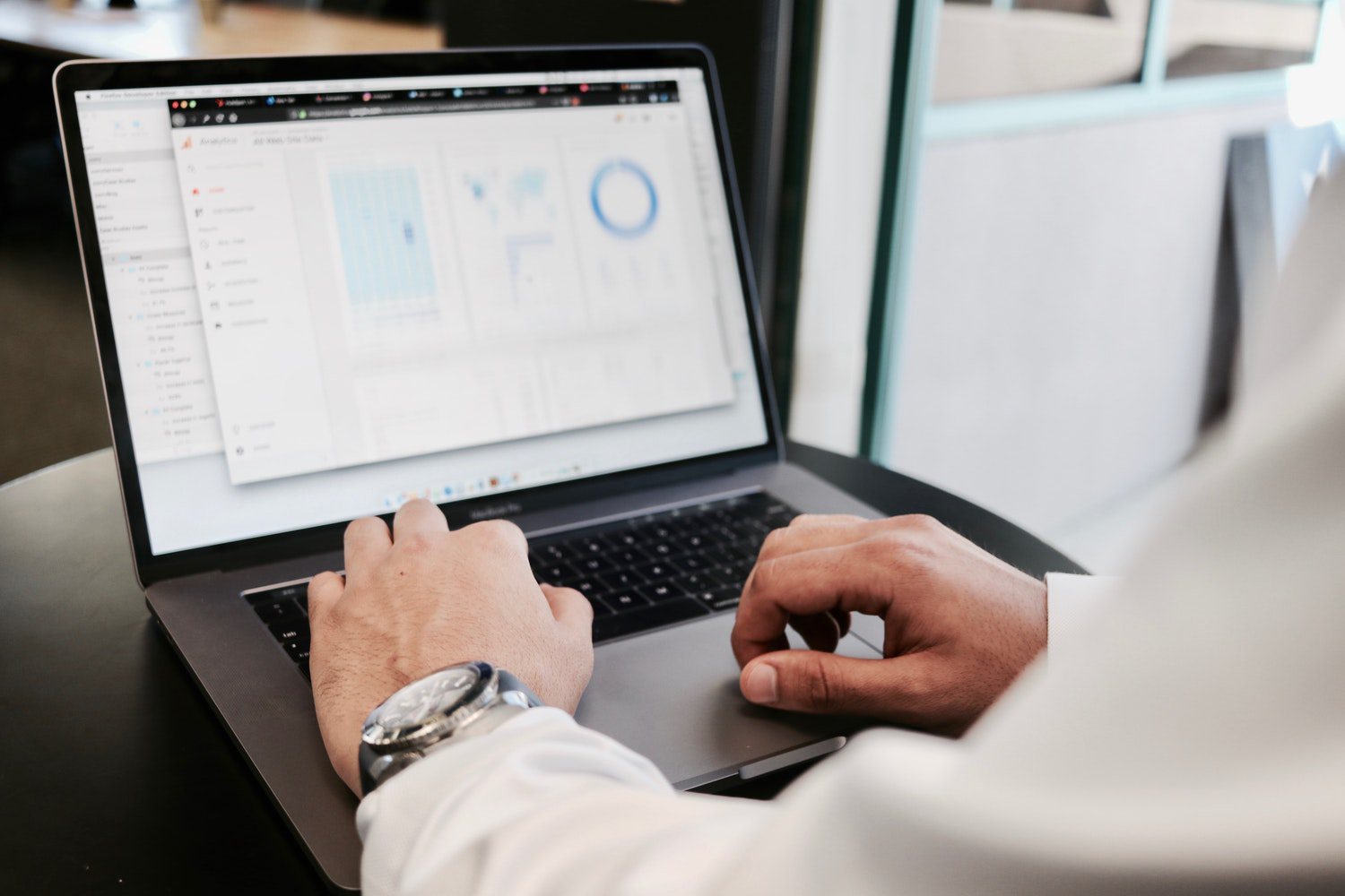 man looking at data on a laptop